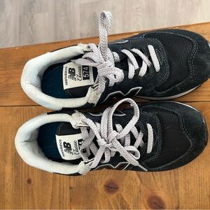 New Balance women’s Black and White 574 Sneakers